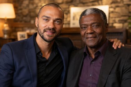 Actor Jesse Williams sitting closely and smiling with his father, Reginald Williams.