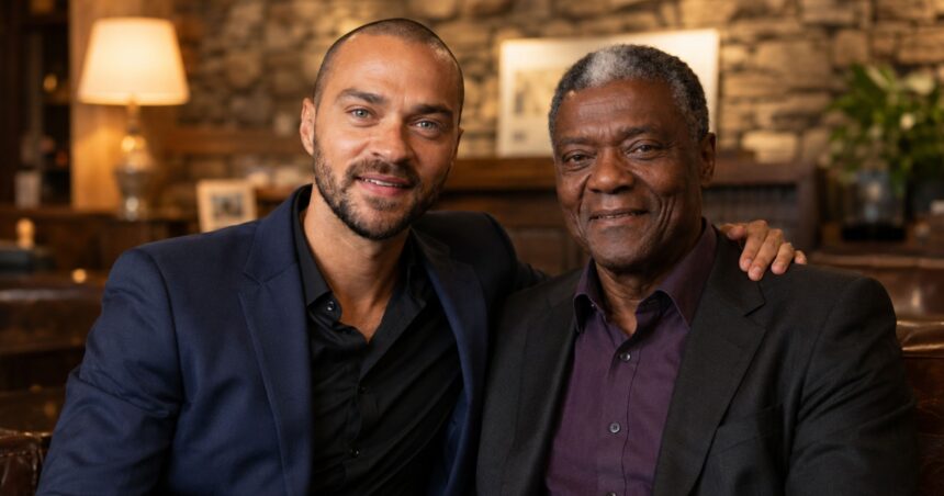 Actor Jesse Williams sitting closely and smiling with his father, Reginald Williams.