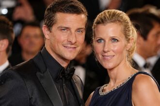 Bear Grylls and his wife Shara Cannings Knight posing together at a red carpet event.