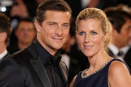 Bear Grylls and his wife Shara Cannings Knight posing together at a red carpet event.