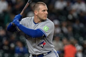 Outfielder Daulton Varsho holding a bat in his Toronto Blue Jays uniform before his trade to the Houston Astros.