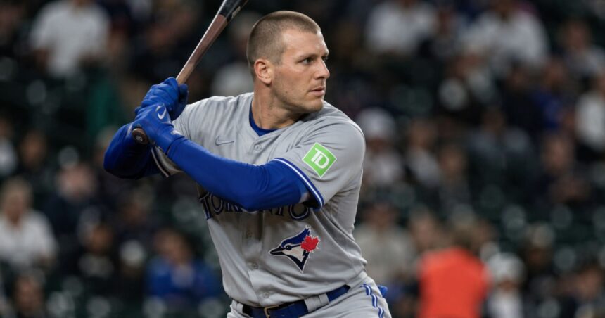 Outfielder Daulton Varsho holding a bat in his Toronto Blue Jays uniform before his trade to the Houston Astros.