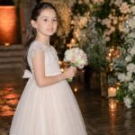 Young Isla Lampard holding a flower bouquet at a family celebration