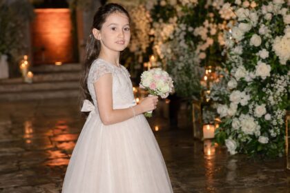 Young Isla Lampard holding a flower bouquet at a family celebration