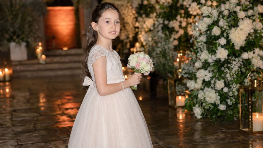 Young Isla Lampard holding a flower bouquet at a family celebration