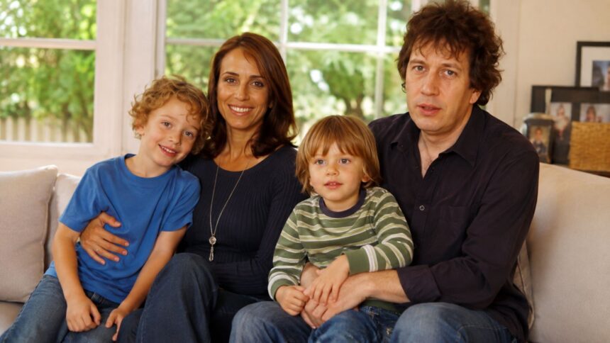 A portrait of broadcast journalist Rachel Royce and columnist Rod Liddle sitting on a sofa with their two young sons, Tyler and Wilder.