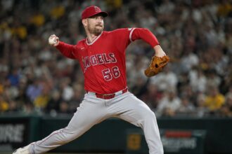 Relief pitcher Ryan Zeferjahn throwing a pitch in a red Los Angeles Angels uniform before his trade to the Chicago Cubs.
