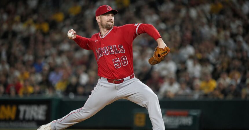 Relief pitcher Ryan Zeferjahn throwing a pitch in a red Los Angeles Angels uniform before his trade to the Chicago Cubs.